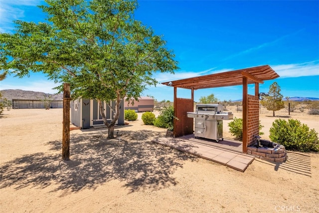 60849 Duvall Dr, Joshua Tree, CA 92252 - view of patio / terrace with an outbuilding, a mountain view, a storage shed, a pergola, and fence