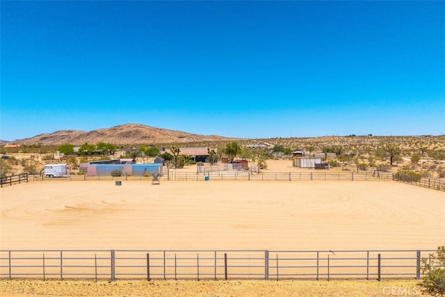 60849 Duvall Dr, Joshua Tree, CA 92252 - view of yard featuring an enclosed horse arena, a mountain view, a view of countryside, and fence