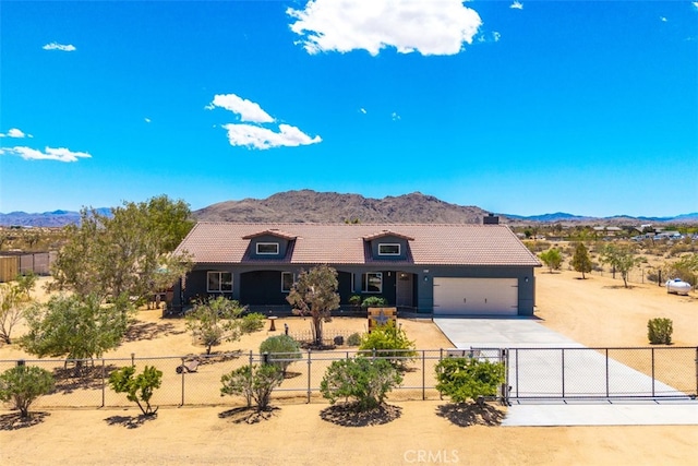 60849 Duvall Dr, Joshua Tree, CA 92252 - single story home with a mountain view, driveway, fence, and a garage