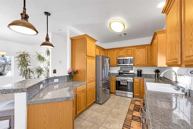 60849 Duvall Dr, Joshua Tree, CA 92252 - kitchen with appliances with stainless steel finishes, a sink, light tile patterned floors, hanging light fixtures, and brown cabinetry