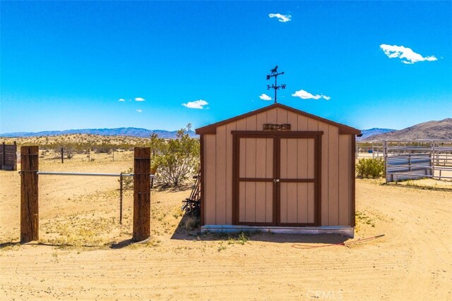 60849 Duvall Dr, Joshua Tree, CA 92252 - view of shed with a mountain view and fence