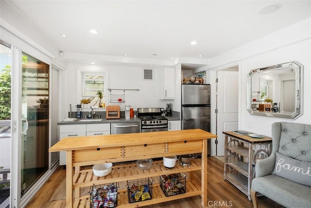 385 Mermaid, Laguna Beach, CA 92651 - kitchen featuring stainless steel appliances, white cabinets, light wood-style flooring, a sink, and recessed lighting