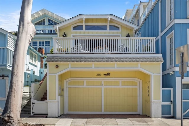 385 Mermaid, Laguna Beach, CA 92651 - view of front of house featuring a garage, a balcony, and driveway