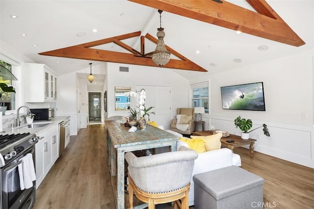 385 Mermaid, Laguna Beach, CA 92651 - kitchen with stainless steel appliances, a sink, white cabinetry, wood finished floors, and glass insert cabinets