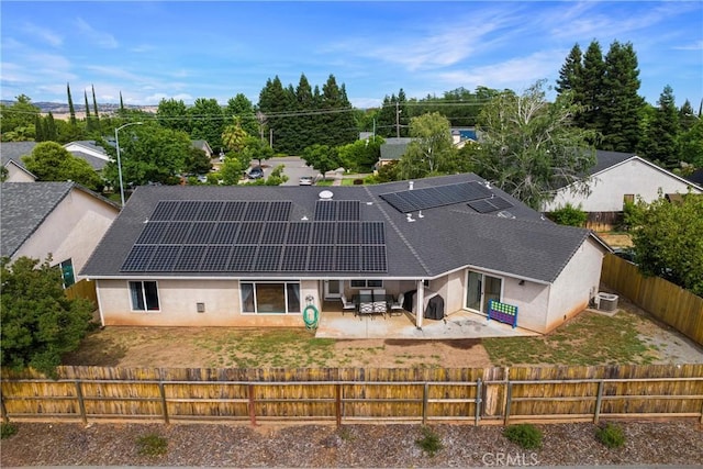 6 Vintage Ct, Chico, CA 95973 - back of property featuring a fenced backyard, a patio, central AC, and solar panels