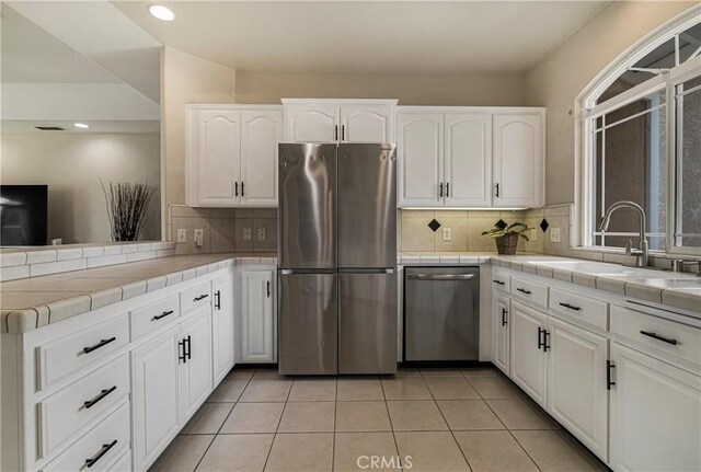 6 Vintage Ct, Chico, CA 95973 - kitchen featuring appliances with stainless steel finishes, tile countertops, decorative backsplash, white cabinetry, and recessed lighting