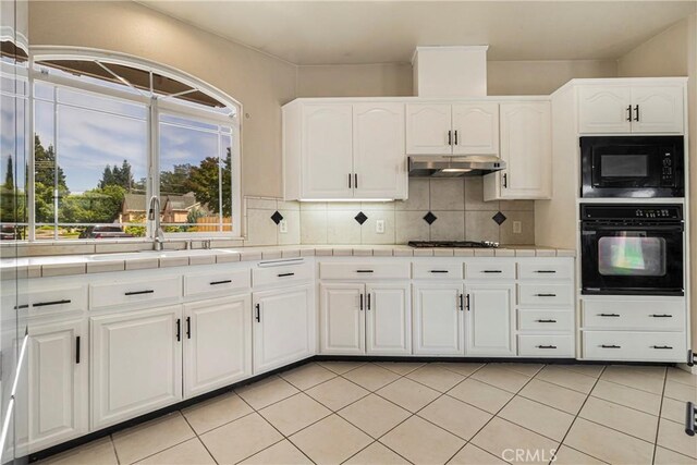 6 Vintage Ct, Chico, CA 95973 - kitchen featuring black appliances, tile countertops, under cabinet range hood, and decorative backsplash
