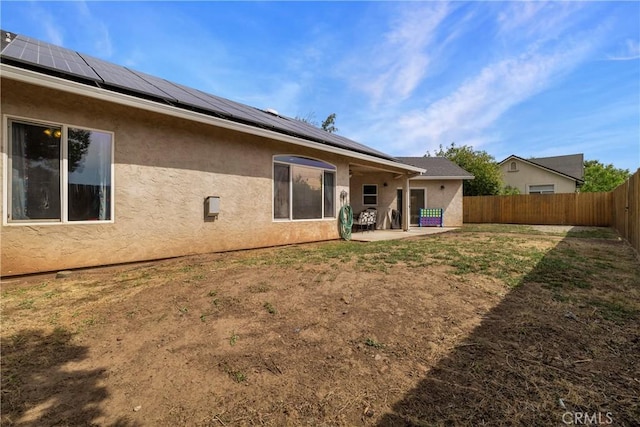 6 Vintage Ct, Chico, CA 95973 - back of house with stucco siding, a patio area, and roof mounted solar panels