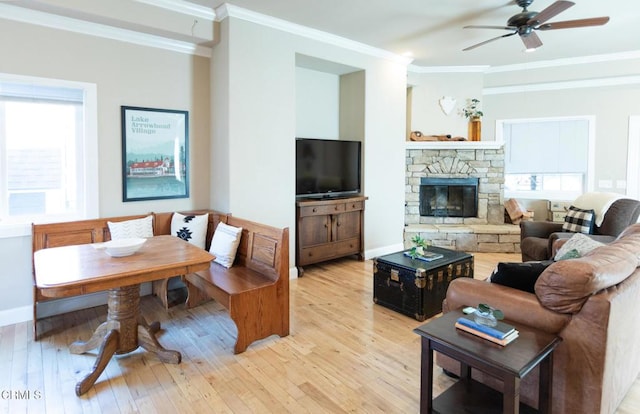 385 Spruce Dr, Lake Arrowhead, CA 92352 - living area featuring a ceiling fan, healthy amount of natural light, light wood-style flooring, crown molding, and a fireplace