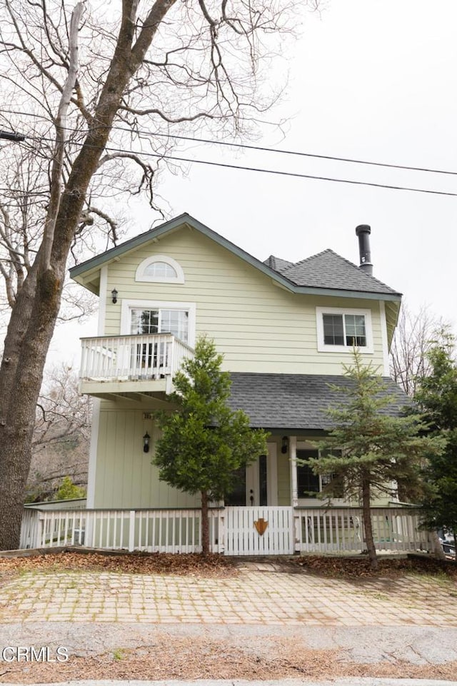 385 Spruce Dr, Lake Arrowhead, CA 92352 - view of front of home featuring a balcony, a shingled roof, and a porch