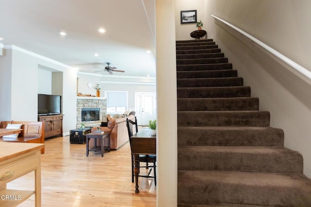 385 Spruce Dr, Lake Arrowhead, CA 92352 - stairway featuring crown molding, ceiling fan, hardwood / wood-style flooring, a fireplace, and recessed lighting