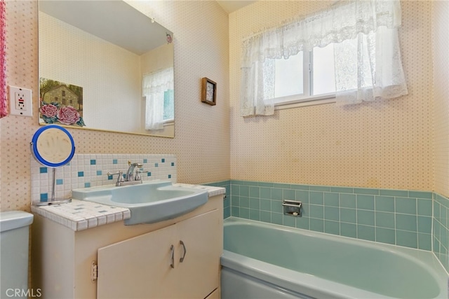 16520 Simonds St, Granada Hills, CA 91344 - bathroom with a garden tub, vanity, toilet, and wallpapered walls
