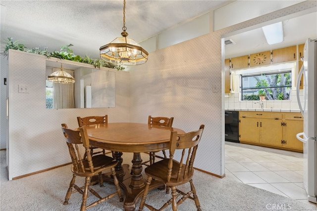 16520 Simonds St, Granada Hills, CA 91344 - dining area featuring a chandelier, wallpapered walls, light colored carpet, and baseboards