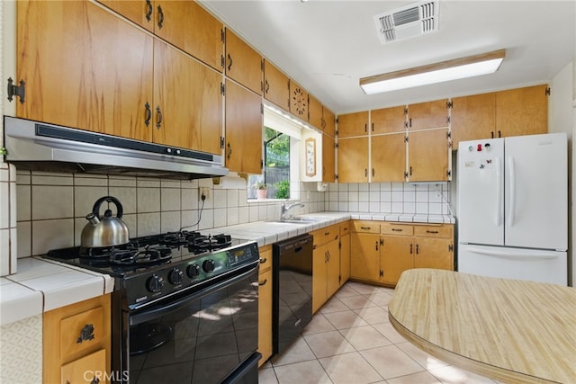 16520 Simonds St, Granada Hills, CA 91344 - kitchen featuring black appliances, under cabinet range hood, decorative backsplash, tile counters, and a sink