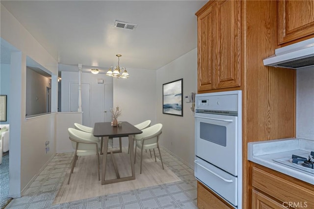 1012 W Lime Ave, Lompoc, CA 93436 - dining space featuring a chandelier, light flooring, and baseboards