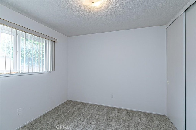 1012 W Lime Ave, Lompoc, CA 93436 - unfurnished room featuring carpet flooring, a textured ceiling, and baseboards