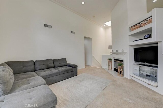 2643 Dietrich Dr, Tustin, CA 92782 - living area featuring carpet floors, crown molding, built in features, a skylight, and recessed lighting