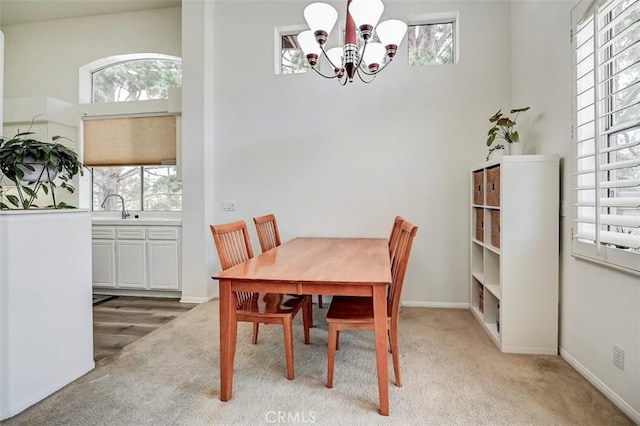 2643 Dietrich Dr, Tustin, CA 92782 - dining room with light colored carpet, a chandelier, and baseboards