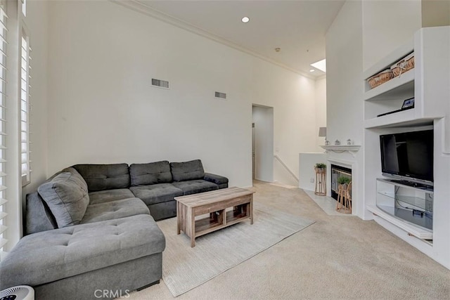 2643 Dietrich Dr, Tustin, CA 92782 - living area featuring light colored carpet, crown molding, built in features, a high ceiling, and a fireplace with flush hearth