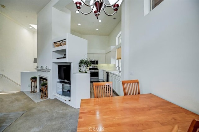2643 Dietrich Dr, Tustin, CA 92782 - dining room featuring a chandelier, recessed lighting, light carpet, and a high ceiling
