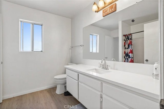 21814 Belshire Ave Unit 2, Hawaiian Gardens, CA 90716 - full bathroom with vanity, wood finished floors, toilet, a shower with shower curtain, and baseboards