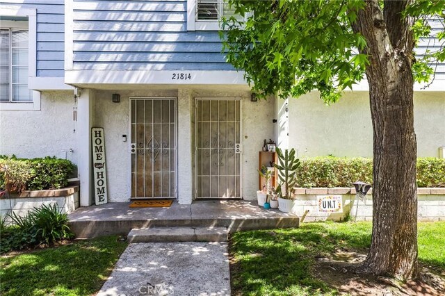21814 Belshire Ave Unit 2, Hawaiian Gardens, CA 90716 - property entrance with stucco siding and a porch