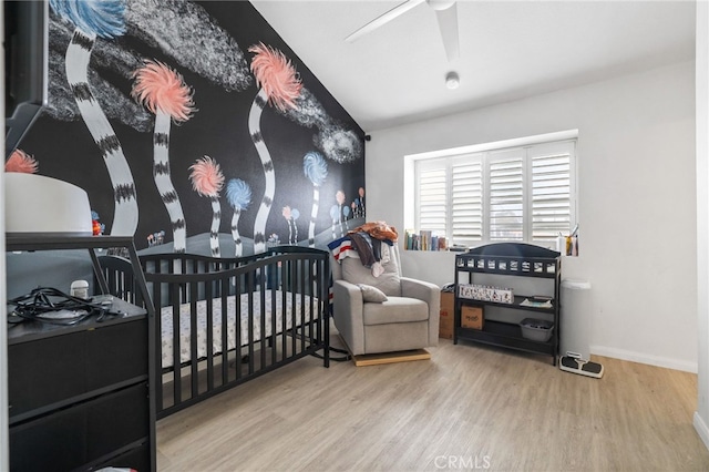 21814 Belshire Ave Unit 2, Hawaiian Gardens, CA 90716 - bedroom featuring wood finished floors, a nursery area, lofted ceiling, a ceiling fan, and baseboards