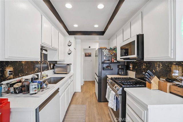21814 Belshire Ave Unit 2, Hawaiian Gardens, CA 90716 - kitchen with stainless steel range with gas cooktop, a sink, light wood finished floors, dishwasher, and decorative backsplash