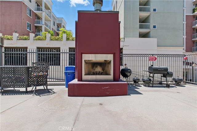 3750 Santa Rosalia Dr Unit 614, Los Angeles, CA 90008 - view of patio / terrace featuring exterior fireplace and area for grilling