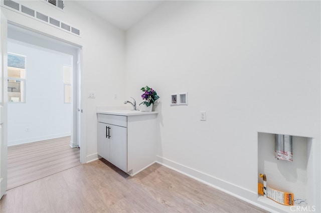 196 Episode, Irvine, CA 92618 - laundry room featuring light wood-style flooring, baseboards, and washer hookup