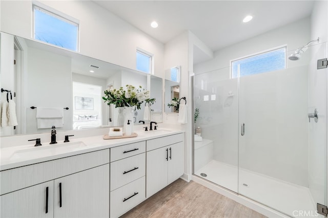 196 Episode, Irvine, CA 92618 - bathroom with a stall shower, double vanity, healthy amount of natural light, and wood finished floors