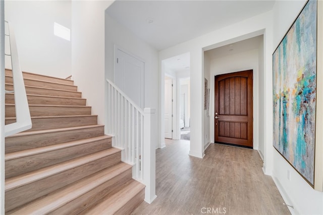 196 Episode, Irvine, CA 92618 - foyer entrance with light wood-style flooring, stairway, and baseboards