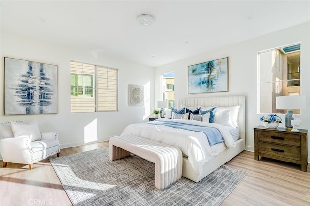 196 Episode, Irvine, CA 92618 - bedroom featuring multiple windows, light wood-style floors, and baseboards