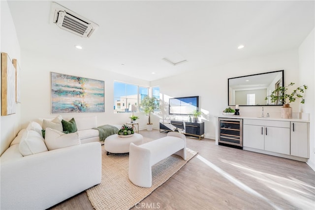 196 Episode, Irvine, CA 92618 - living area with beverage cooler, bar with sink, light wood-style flooring, and recessed lighting