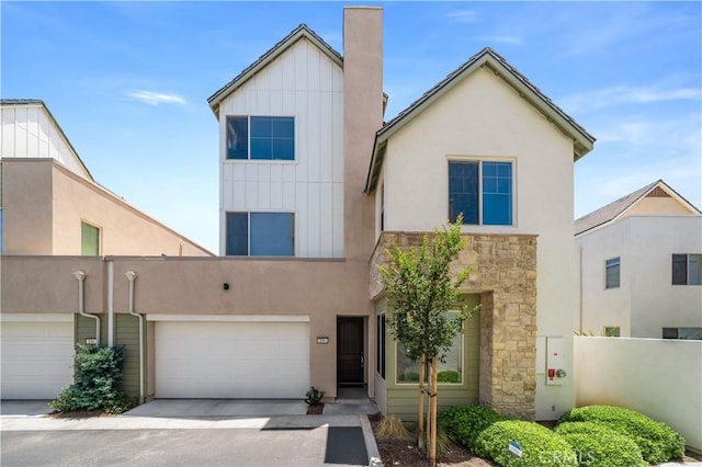 196 Episode, Irvine, CA 92618 - view of front of house featuring stone siding, an attached garage, board and batten siding, and concrete driveway