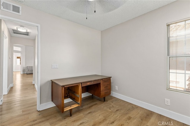 6249 Firestone Cir, Banning, CA 92220 - unfurnished office featuring a textured ceiling, light wood-type flooring, baseboards, and a ceiling fan