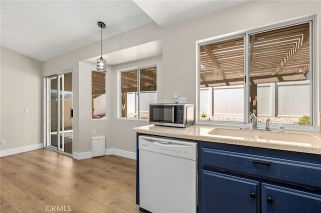 6249 Firestone Cir, Banning, CA 92220 - kitchen with blue cabinets, dishwasher, stainless steel microwave, a sink, and light wood-type flooring