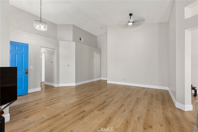 6249 Firestone Cir, Banning, CA 92220 - unfurnished living room with ceiling fan, high vaulted ceiling, baseboards, and light wood-style floors