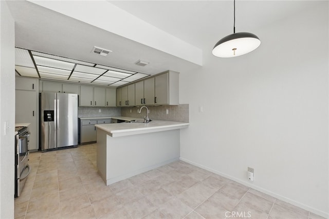 4424 Park Jazmin, Calabasas, CA 91302 - kitchen with stainless steel appliances, a peninsula, light countertops, a sink, and decorative backsplash