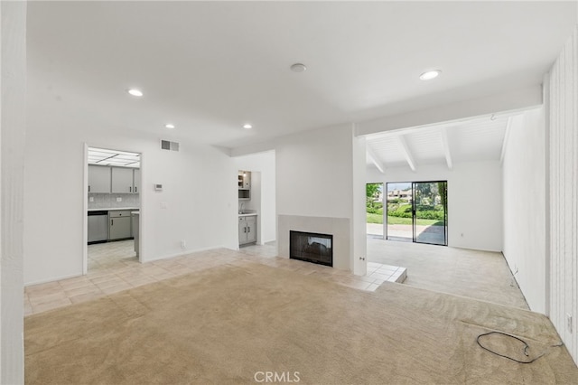 4424 Park Jazmin, Calabasas, CA 91302 - unfurnished living room featuring light colored carpet, recessed lighting, a tile fireplace, and light tile patterned floors