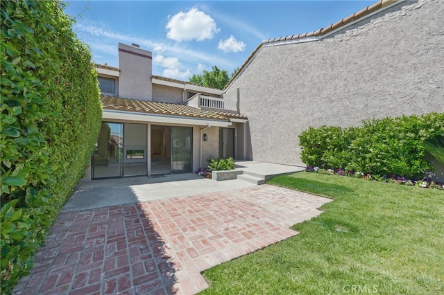 4424 Park Jazmin, Calabasas, CA 91302 - back of property featuring stucco siding, a tiled roof, a chimney, a patio, and a lawn