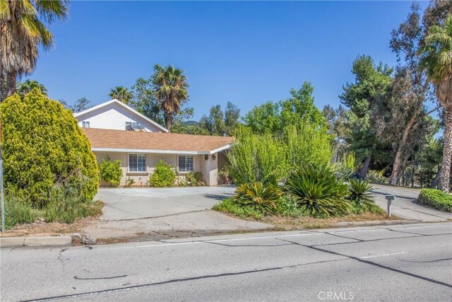 11425 Bryant St, Yucaipa, CA 92399 - view of front of house featuring stucco siding and concrete driveway