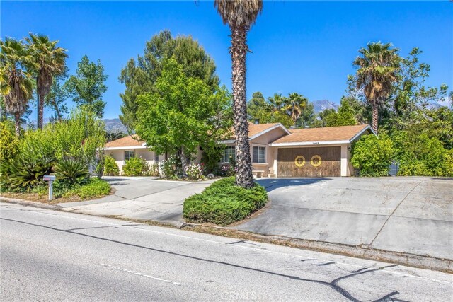 11425 Bryant St, Yucaipa, CA 92399 - view of front of house with curved driveway, stucco siding, and stone siding