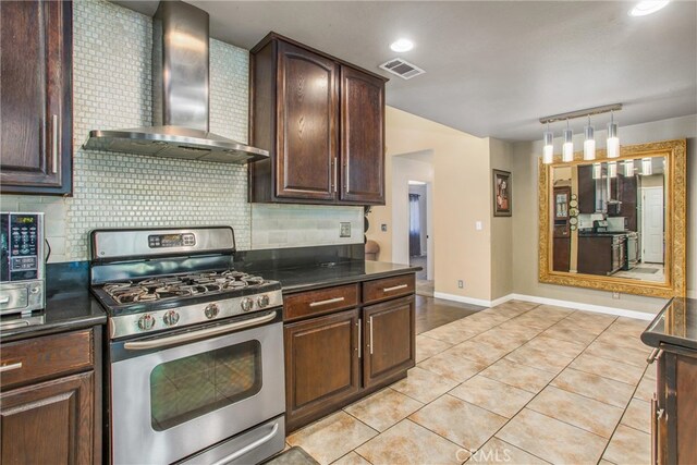 11425 Bryant St, Yucaipa, CA 92399 - kitchen featuring wall chimney exhaust hood, stainless steel gas range oven, dark countertops, and tasteful backsplash