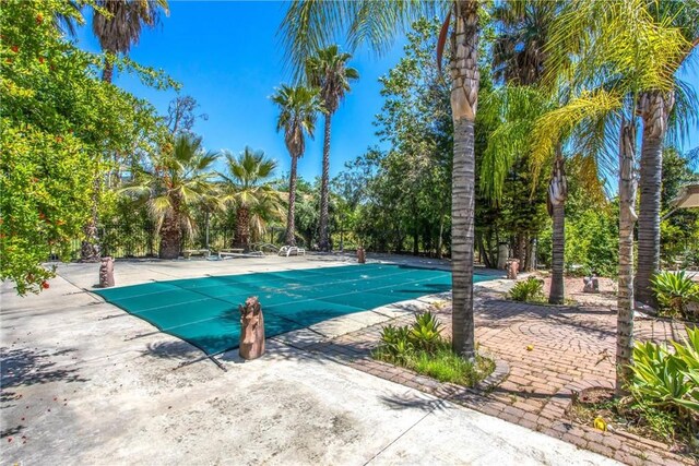 11425 Bryant St, Yucaipa, CA 92399 - view of swimming pool featuring a covered pool and a patio