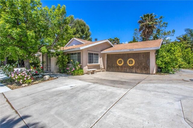 11425 Bryant St, Yucaipa, CA 92399 - ranch-style home with driveway, an attached garage, and stucco siding