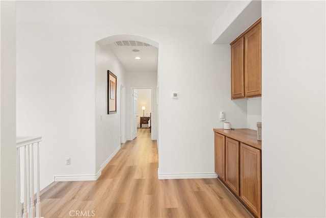 23911 Brio Ct, Valencia, CA 91354 - hall with light wood-style flooring, baseboards, arched walkways, and recessed lighting
