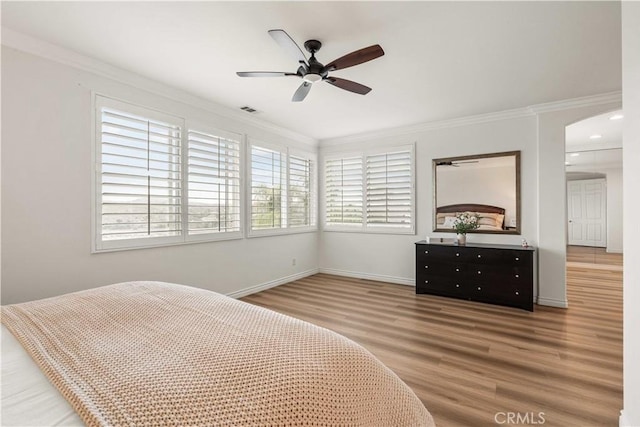 23911 Brio Ct, Valencia, CA 91354 - bedroom with wood finished floors, ornamental molding, arched walkways, baseboards, and ceiling fan