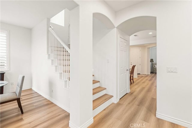 23911 Brio Ct, Valencia, CA 91354 - stairs with wood finished floors, arched walkways, and baseboards