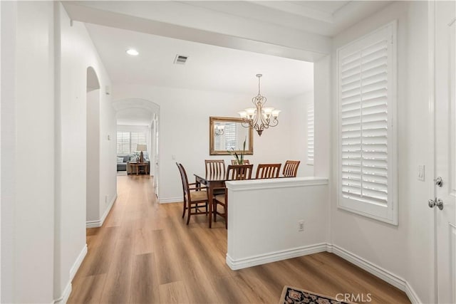 23911 Brio Ct, Valencia, CA 91354 - dining space with light wood-type flooring, arched walkways, baseboards, recessed lighting, and a chandelier